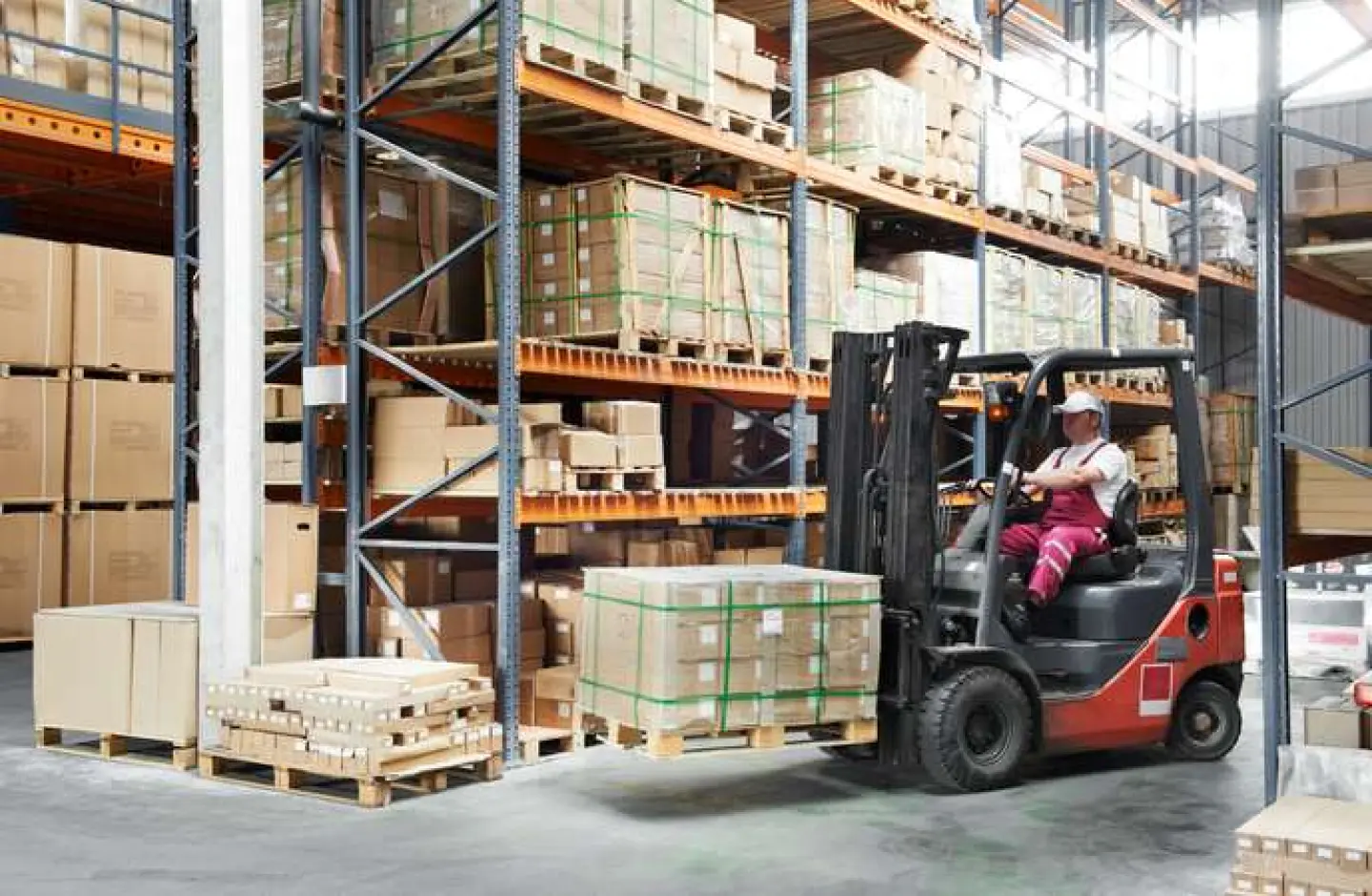 Image of a forklift in action inside a warehouse.